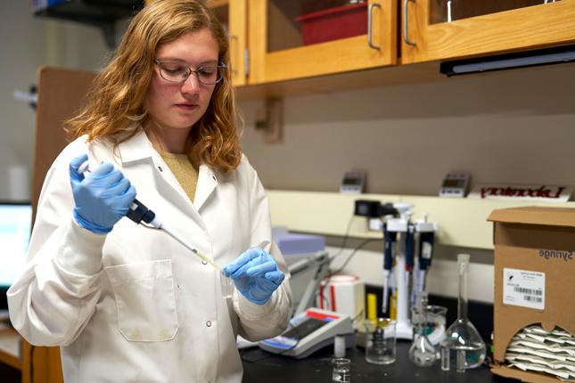 Heather Ricker, a Skidmore College student, drops nitrogen in a test tube in a chemistry lab